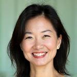 Sarah Chen, 42, smiling enthusiastically.
